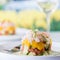 A light and airy photo of a crab stack salad against a soft focus background.