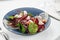 Light appetizer bresaola with lettuce, Italian bresaola beef jerky on a light plate, close-up, copy space