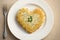 light appetizing potato pancakes in shape of heart for breakfast