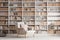 light armchair near a large bookcase on gray wall background in living room