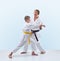 On a light background with black belt a master teaches athlete