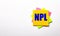 On a light background - bright multicolored stickers with the text NPL Non Performing Loan. Copy space