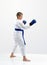 On a light background karateka boy with blue overlays on hands