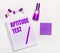 On a light background - a lilac gift, perfume, lilac business accessories and a notebook with a lilac inscription APTITUDE TEST.