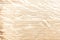 A light background of wood scorched on the edge. Texture, diagonal, soft wavy lines.