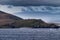 Light beacon on Hornos island under cloudscape, Cape Horn, Chile