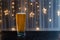 Light beer in a figured glass on a black table