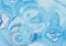 Light blue abstract liquid paint textured background with decorative spirals and swirls