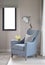 Light blue armchair with gray pillow and retro lamp in the living room