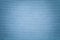 Light blue background from a textile material. Fabric with natural texture. Backdrop