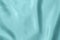 Light blue colored Background of soft draped fabric