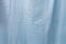 Light blue creased fabric close-up, top view background