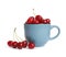 Light blue cup of delicious ripe sweet cherries