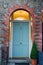 Light blue Dublin Door over brick wall