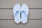 Light Blue Flip Flops on Gray Deck Background