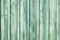 Light blue-green weathered wooden fence