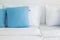 Light blue pillows white bed