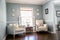 Light blue sitting room with two cream colored chairs and decorative plates on the wall