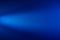 Light blue straight beam of light on a blue textural background