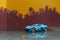 Light blue super car toy selective focus on blur city background