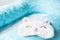 Light blue supporting pillow with stars on white sheet in bed for comfortable sleep of pregnant woman. Funny sleeping mask in form