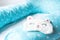 Light blue supporting pillow with stars on white sheet in bed for comfortable sleep of pregnant woman. Funny sleeping mask in form