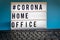 A light box with the inscription: #CORONA HOME OFFICE