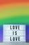 Light box with `love is love` and rainbow