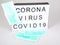 Light box with text coronavirus with blue protective mask