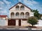 Light brick two-storey house with iron gates