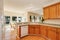 Light brown kitchen cabinets and white appliances