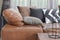 Light brown leather sofa bed with varies color and size pillows