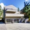 Light brown modern house exterior in spring forest.