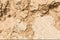 Light brown rock texture. Rough mountain surface. Close-up. Beige stone background with space for design.