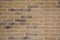 Light brown stone brick exterior wall in hard light emphasizing stones textures and depth