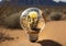 Light bulb with a cactus inside on the background of the desert. Earth day, protection and conservation of energy.