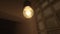 Light bulb without lamp hanging from the ceiling in the dark. Stock footage. Lighting of an old and gloomy with colorful