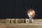 Light bulb with light flare, wooden cube block with alphabet text THINK on wood table. symbol of creativity.