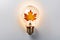 Light bulb made from maple and autumn leaves. renewable energy and sustainable living concept