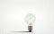 A light bulb, one, standing upright on a white background