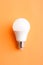 Light bulb on orange background