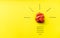 Light bulb over yellow background in vision and idea conceptual image. Conceptual image of creativity. Symbol of