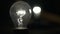The light bulb pulsates against a black background, the pulsation of incandescent light, the dimmer