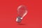 Light bulb on red background. Top view