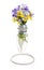 Light bulb vase with a bouquet of wildflowers on a decorative stand made of wire, isolated on white background