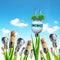 Light bulb with wind turbines,solar panel and coins on a plant. Concept of saving money.