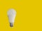 Light bulb on yellow background, idea, artificial light source, concept of new ideas, top view, copy space