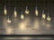 Light bulbs on brick wall background. Realistic glowing Edison lamps. Loft interior objects. Lightbulbs hanging on wire