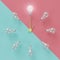 Light bulbs glowing one different idea clock concept on cross pastel pink and light blue background