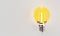 Light bulbs with incandescent bulbs glow yellow on white draft office graph paper. Thinking and imagination idea concept. 3D